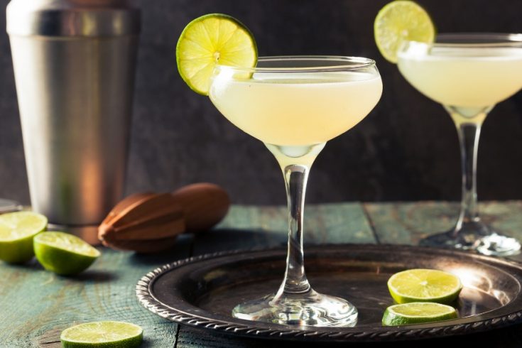 Two traditional Lime Daiquiris on a tray with slices of Lime