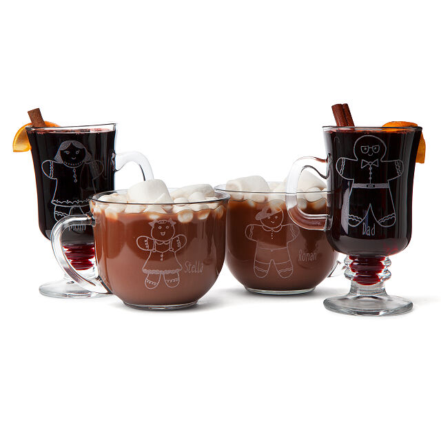 A selection of mulled wine and hot cocoa glasses with gingerbread men etchings