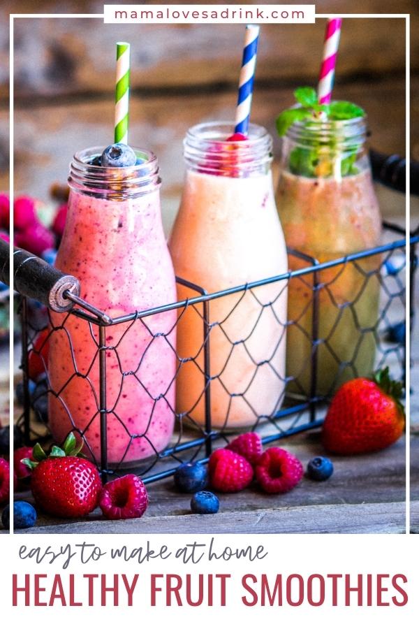 beautiful fruit smoothies served in old style milk bottles with straws, colorfully decorated with berries