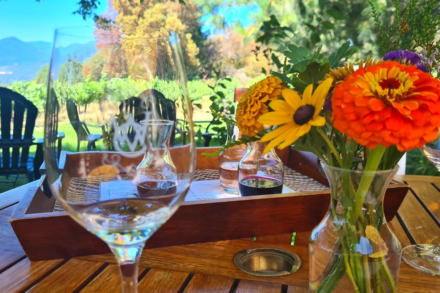 a close up of tasting glasses and flowers at woolridge creek winery in applegate valley AVA in southern oregon